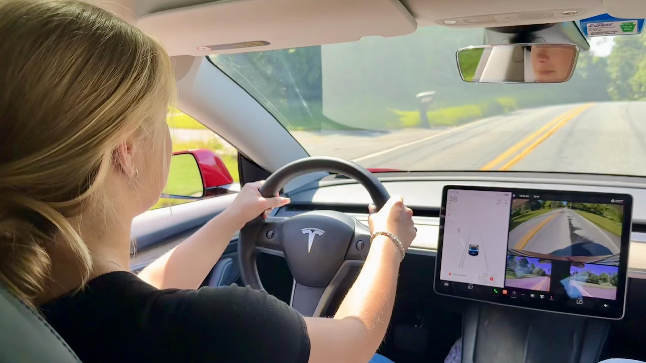 teen driving a Tesla