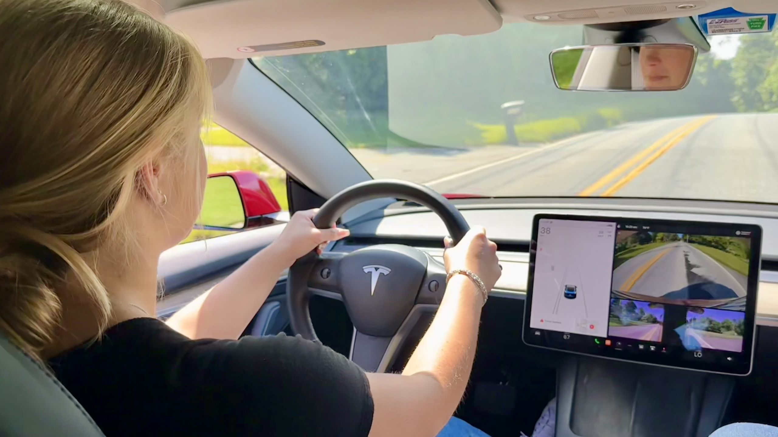 teen driving a Tesla